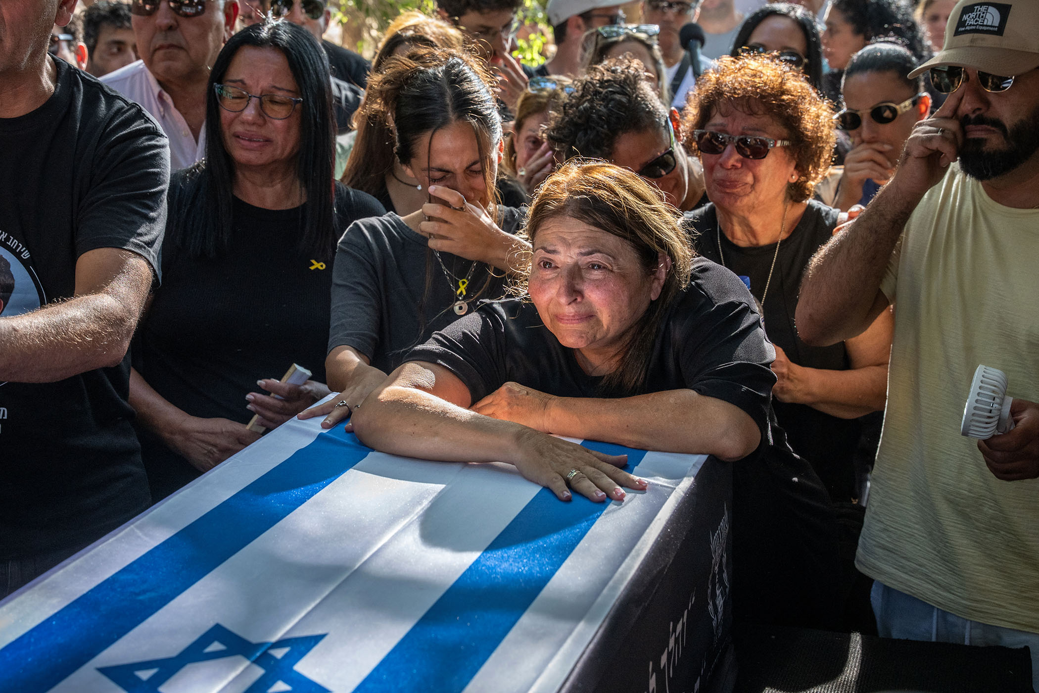 As living hostages return, a long wait begins for the dead